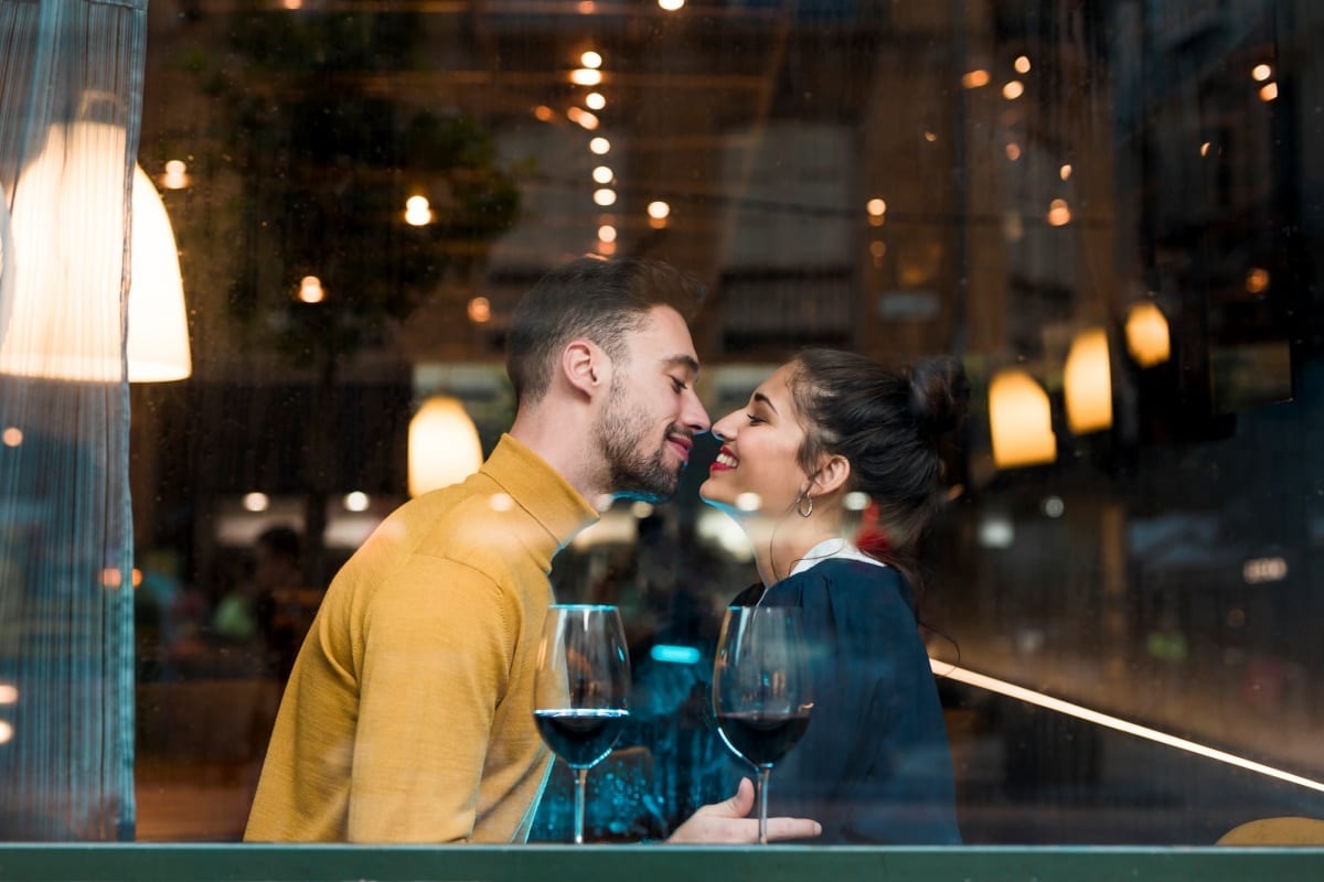 happy-man-woman-near-glasses-wine-restaurant